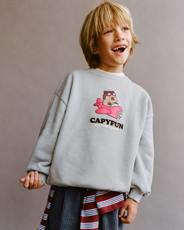 Boy wearing a CapyFun capybara sweatshirt